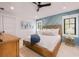 Cozy bedroom featuring a statement wall, comfortable bed, stylish decor, and ample natural light at 128 Fillmore Dr, Sarasota, FL 34236
