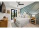 Inviting bedroom featuring a statement wall, comfortable bed, balcony access, and stylish decor at 128 Fillmore Dr, Sarasota, FL 34236