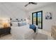 Primary bedroom featuring patterned accent wall and balcony access at 128 Fillmore Dr, Sarasota, FL 34236