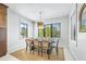 Bright dining room with a table and seating for six, illuminated with modern lighting at 128 Fillmore Dr, Sarasota, FL 34236