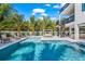 Beautiful backyard with sparkling pool, sun loungers, cabana, and spiral staircase, perfect for relaxation and entertaining at 128 Fillmore Dr, Sarasota, FL 34236