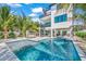 Impressive backyard showcasing a sparkling pool, sun loungers, cabana, and spiral staircase, offering resort-style living at 128 Fillmore Dr, Sarasota, FL 34236