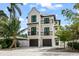 Modern two-story home with two-car garage, balconies, and sleek, minimalist design at 128 Fillmore Dr, Sarasota, FL 34236