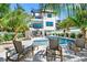 Beautiful home exterior showcasing a backyard pool, cabana, spiral staircase, and palm trees, perfect for outdoor living at 128 Fillmore Dr, Sarasota, FL 34236