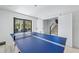 Bright game room featuring a ping pong table, neutral decor, and natural light, perfect for entertainment and recreation at 128 Fillmore Dr, Sarasota, FL 34236