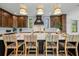Spacious kitchen features a large island, bar seating, and modern lighting fixtures at 128 Fillmore Dr, Sarasota, FL 34236