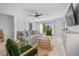 Bright living room with comfortable seating, balcony access, stylish decor, and entertainment center at 128 Fillmore Dr, Sarasota, FL 34236