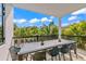 Covered outdoor dining area with seating for ten and a view of the landscaping at 128 Fillmore Dr, Sarasota, FL 34236
