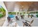 Spacious outdoor living area with ceiling fans, ample seating, foosball table and a beautiful pool area at 128 Fillmore Dr, Sarasota, FL 34236