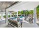 Inviting outdoor living area with a spiral staircase leading to a refreshing pool and lounge area at 128 Fillmore Dr, Sarasota, FL 34236