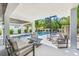 Chic outdoor living space with comfortable seating and a spiral staircase leading to a refreshing pool at 128 Fillmore Dr, Sarasota, FL 34236