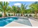 Inviting backyard featuring a refreshing pool, sun loungers, and lush tropical landscaping, creating a perfect outdoor oasis at 128 Fillmore Dr, Sarasota, FL 34236