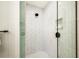 Close up of a bright, modern shower featuring white marble and black fixtures at 128 Fillmore Dr, Sarasota, FL 34236