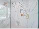 Beautiful shower featuring marble style tile, rainfall shower head, and glass door at 128 Fillmore Dr, Sarasota, FL 34236