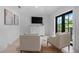 Bright sitting room featuring two chairs, a dresser, and a balcony at 128 Fillmore Dr, Sarasota, FL 34236
