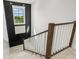 Bright staircase featuring a black accent wall and stylish white wood railing at 128 Fillmore Dr, Sarasota, FL 34236