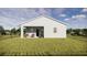 Backyard view of a modern home with a patio, chairs, and black metal fencing at 13046 Bayberry Way, Parrish, FL 34219