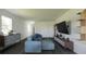 Contemporary living room featuring stylish furniture, a large screen TV, and modern decor accents at 13046 Bayberry Way, Parrish, FL 34219