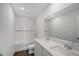 Bright bathroom featuring double sinks, quartz countertop, large mirror, and tiled shower-tub combo at 13117 Bayberry Way, Parrish, FL 34219
