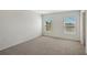 Bright, carpeted bedroom with two windows offering natural light, creating a peaceful and inviting atmosphere at 13117 Bayberry Way, Parrish, FL 34219