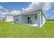 A covered patio with a green lawn in the backyard at 13136 Bayberry Way, Parrish, FL 34219