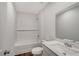 Bathroom with a shower-tub combination, white subway tile surround, and a quartz vanity top at 13136 Bayberry Way, Parrish, FL 34219