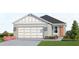 Charming home showcasing a two-car garage, well-maintained landscaping, and tasteful exterior lighting fixtures at 13136 Bayberry Way, Parrish, FL 34219