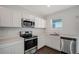 Well-equipped kitchen boasts stainless steel appliances, white cabinetry, and ample counter space for meal preparation at 13136 Bayberry Way, Parrish, FL 34219