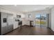 Modern kitchen featuring stainless steel appliances, white cabinets, and a sliding glass door for natural light at 13136 Bayberry Way, Parrish, FL 34219
