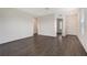 Spacious living room showcasing dark wood flooring, neutral walls, and ample natural light from a nearby window at 13136 Bayberry Way, Parrish, FL 34219