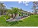 Villa exterior featuring lush landscaping, white rock accents, and a well-maintained lawn at 139 Vista Hermosa Circle, Sarasota, FL 34242
