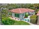 Beautiful villa with lush backyard, patio, and views of mature trees and vibrant greenery at 139 Vista Hermosa Circle, Sarasota, FL 34242