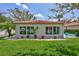 Villa exterior featuring lush landscaping, white rock accents, and well-maintained lawn and garden at 139 Vista Hermosa Circle, Sarasota, FL 34242