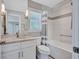 Bathroom features a combination shower and tub with gray and white tile and a marble-topped vanity at 139 Vista Hermosa Circle, Sarasota, FL 34242