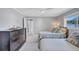Bedroom featuring two twin beds and a wooden dresser under a ceiling fan and next to a window at 139 Vista Hermosa Circle, Sarasota, FL 34242