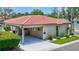 Charming home featuring a red tile roof, well-maintained landscaping, and a convenient covered carport at 139 Vista Hermosa Circle, Sarasota, FL 34242
