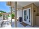 Inviting front entry featuring double glass doors, neutral paint, and a covered patio area at 139 Vista Hermosa Circle, Sarasota, FL 34242
