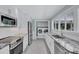 A well-appointed kitchen with stainless steel appliances and a convenient laundry area at 139 Vista Hermosa Circle, Sarasota, FL 34242