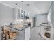Modern kitchen featuring white cabinets, granite countertops, stainless steel appliances, and bar seating at 139 Vista Hermosa Circle, Sarasota, FL 34242