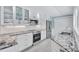 This stunning kitchen features white cabinets, subway tile backsplash, and stainless steel appliances at 139 Vista Hermosa Circle, Sarasota, FL 34242