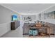 Comfortable living room space with a media center, wainscoting, and backyard view at 139 Vista Hermosa Circle, Sarasota, FL 34242