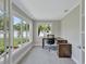 Bright office space features neutral colors, gray flooring, and large windows with views of the surrounding landscape at 139 Vista Hermosa Circle, Sarasota, FL 34242