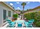 Cozy outdoor patio area with colorful Adirondack chairs, perfect for relaxing and enjoying the Florida sunshine at 139 Vista Hermosa Circle, Sarasota, FL 34242