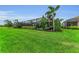 Large, manicured backyard with a covered screened-in lanai, landscaping and plenty of green grass at 15315 Derna Ter, Bradenton, FL 34211