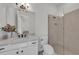 Well-lit bathroom featuring a modern vanity, a decorative mirror, and glass enclosed walk-in shower at 15315 Derna Ter, Bradenton, FL 34211