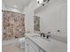 The bathroom includes a floral shower curtain, a countertop with a sink, and a large mirror at 15315 Derna Ter, Bradenton, FL 34211