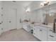 Bathroom featuring double sinks, white marble countertops, white cabinets, and modern lighting fixtures at 15315 Derna Ter, Bradenton, FL 34211