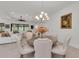 Dining area featuring a round table, seating for six, and views into the living room at 15315 Derna Ter, Bradenton, FL 34211