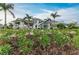 Community entrance and guardhouse featuring white columns and lush landscaping at 15315 Derna Ter, Bradenton, FL 34211