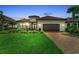 Beautiful single-story home with a well-manicured lawn, paver driveway, and a two-car garage at 15315 Derna Ter, Bradenton, FL 34211